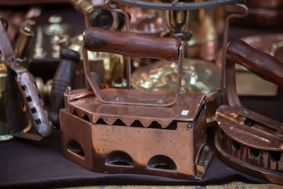 Close-up of old-fashioned ironing machines at market stall