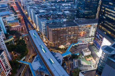 High angle view of illuminated city street and buildings at night