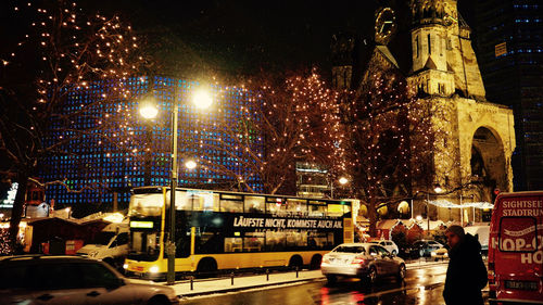 Illuminated city against sky at night