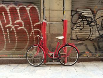 Bicycle parked against brick wall