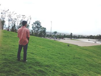 People standing on grassy field