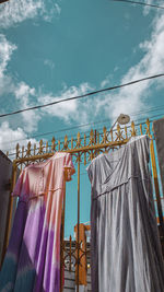 Low angle view of clothes hanging on clothesline against building