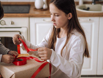 Side view of young woman working at home