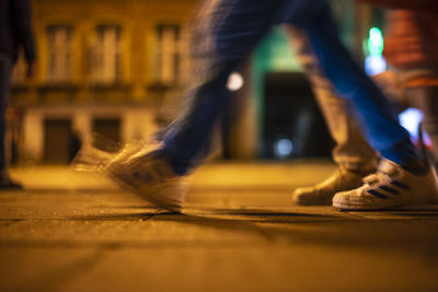 Low section of people standing in illuminated city