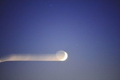 Low angle view of moon against clear sky at night