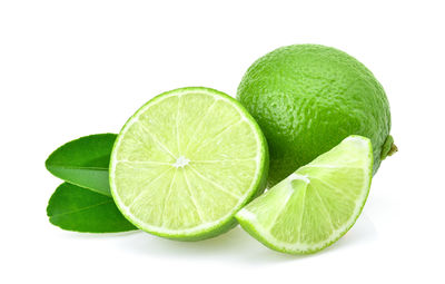 Close-up of green fruit against white background