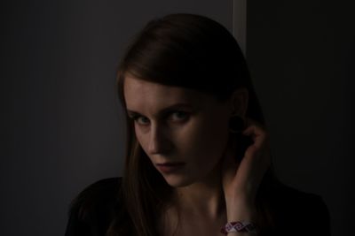 Portrait of beautiful woman over black background