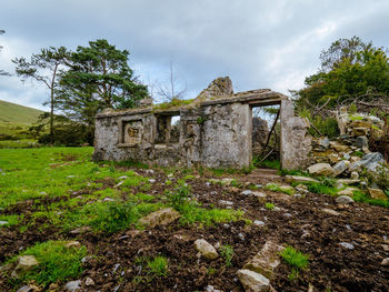 Old ruin on field against sky