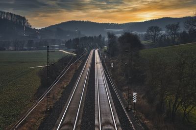 High angle view of railroad tracks against sky during sunset