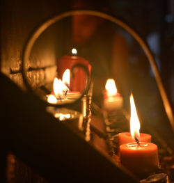 Close-up of lit candles in temple