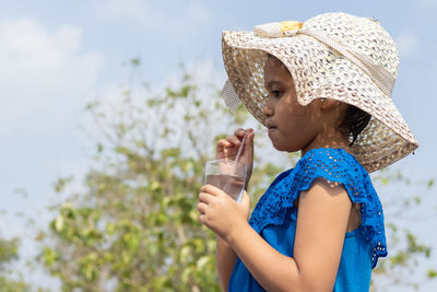 Young woman drinking water from bottle