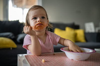 Portrait of cute girl playing with toy at home