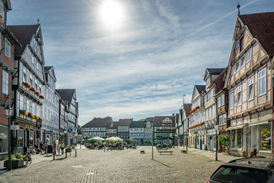 Street amidst buildings in town against sky