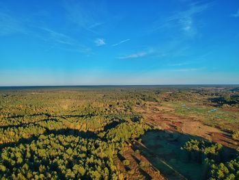 Scenic view of landscape against blue sky