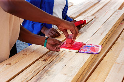 Midsection of carpenter working in workshop