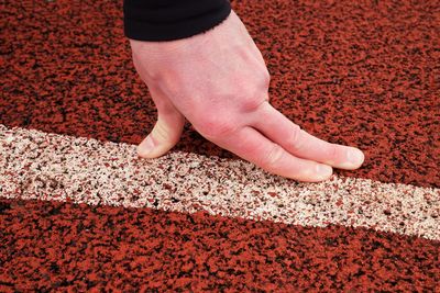 High angle view of hands on rug