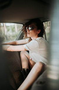 Young woman sitting in car