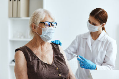 Full length of woman wearing mask