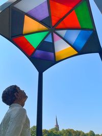 Low angle view of man standing against clear sky