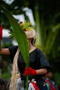 Midsection of woman holding plant