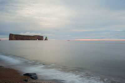 Scenic view of sea against cloudy sky