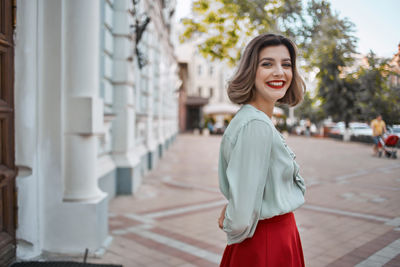 Portrait of smiling young woman standing outdoors