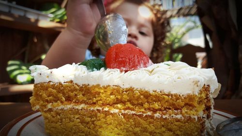 Close-up of baby girl eating cake