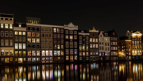 Reflection of illuminated buildings in water at night