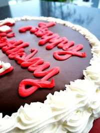 Birthday cake written in butter cream on a ganache spread.