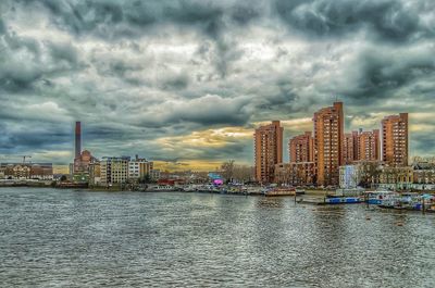 Cityscape against cloudy sky