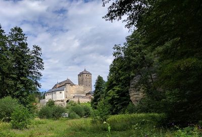 Buildings against cloudy sky