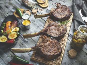 High angle view of roasted lamb chops on table