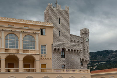 Low angle view of building against cloudy sky