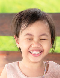 Portrait of four years old happy laughing  asian girl, little child with smile emotion on face.