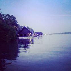 Scenic view of lake by building against sky