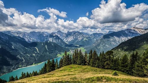 Scenic view of mountains against cloudy sky