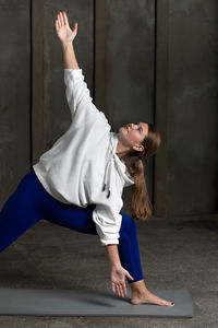 Full length of woman exercising in gym