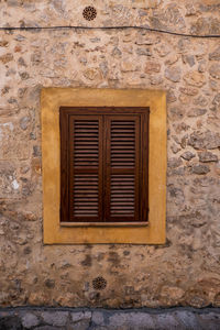 Close-up of window on brick wall