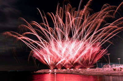 Low angle view of firework display at night