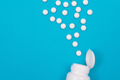 Close-up of human hand against blue background