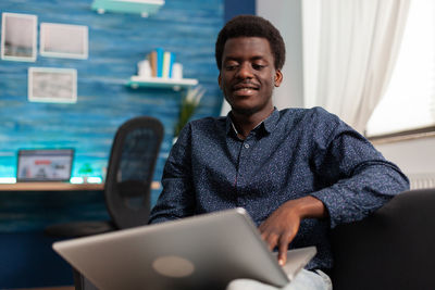 Portrait of young man using mobile phone