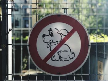 Close-up of sign on railing