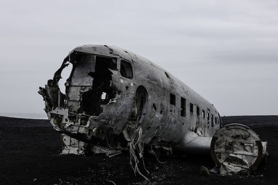 Abandoned airplane against sky