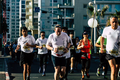 Group of people running in city