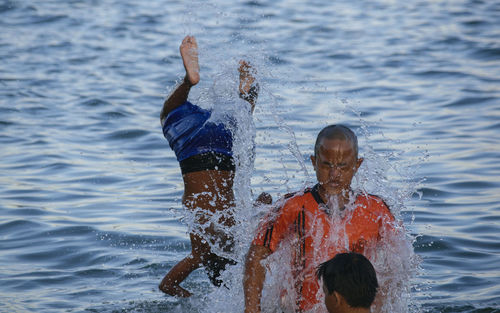 Male friends enjoying in lake