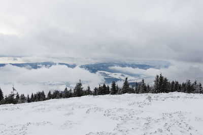 Scenic view of snow covered mountains against sky