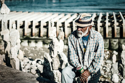 Full length of man standing by water