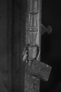 Close-up of padlock hanging on metal door