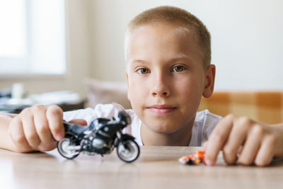 Portrait of boy holding toy car