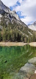 Scenic view of lake by mountains against sky